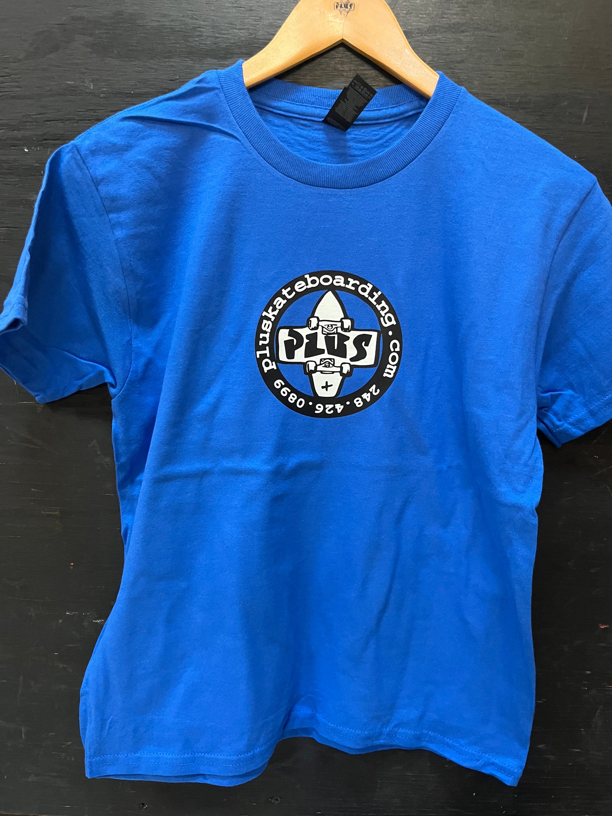 Blue t-shirt with a logo on a black background