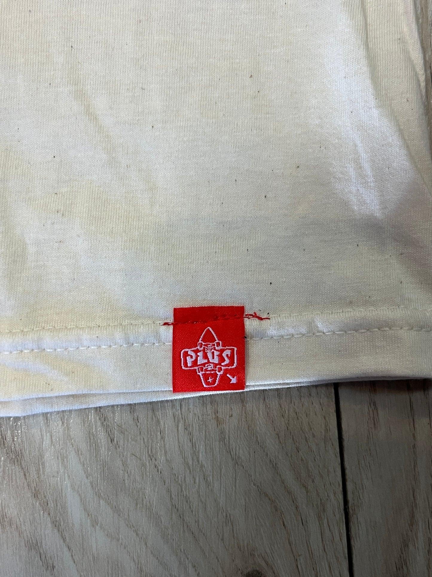 Plus Woven label on tee