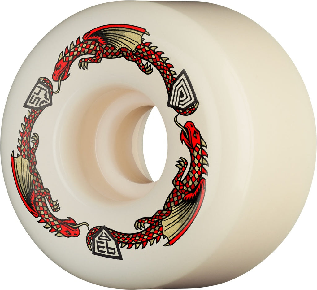An off-white skateboard wheel featuring a circular graphic of two red and black dragons with beige wings, interspersed with black geometric shield-like emblems.