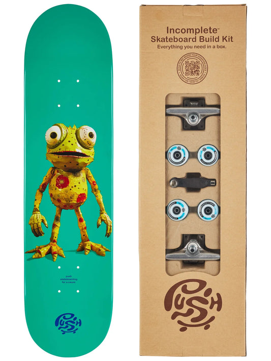 Skateboard deck with a cartoon frog design next to an incomplete skateboard build kit box.