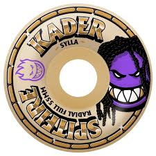 A skateboard wheel featuring 'KADER' and 'SPINNING' text and a purple cartoon face