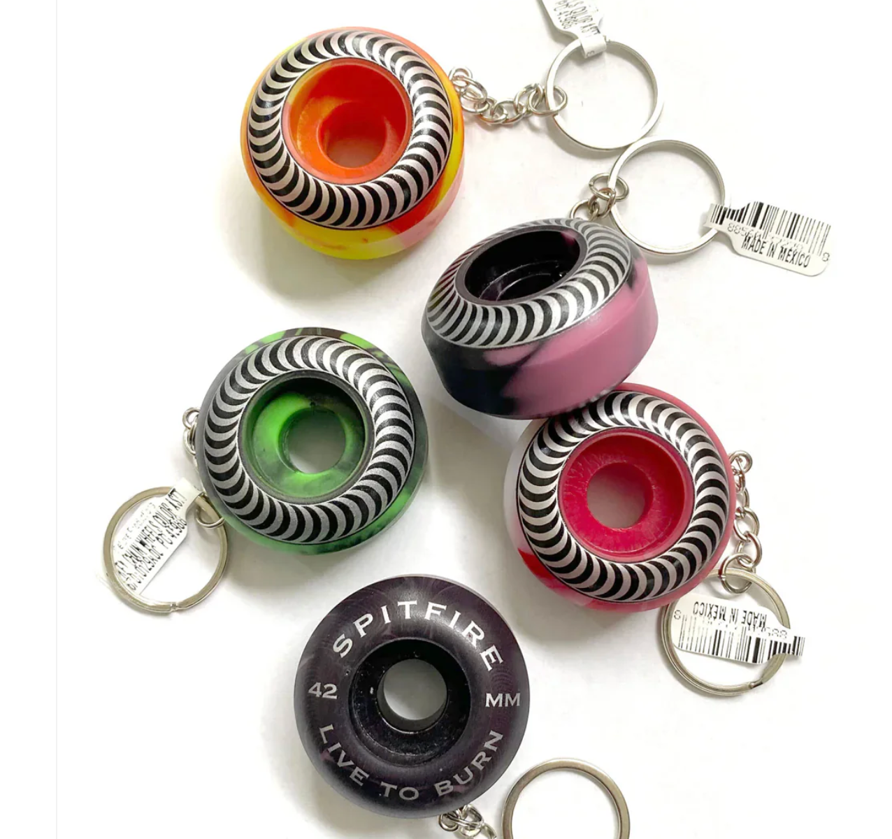 Spitfire skateboard wheel keychains on a white background