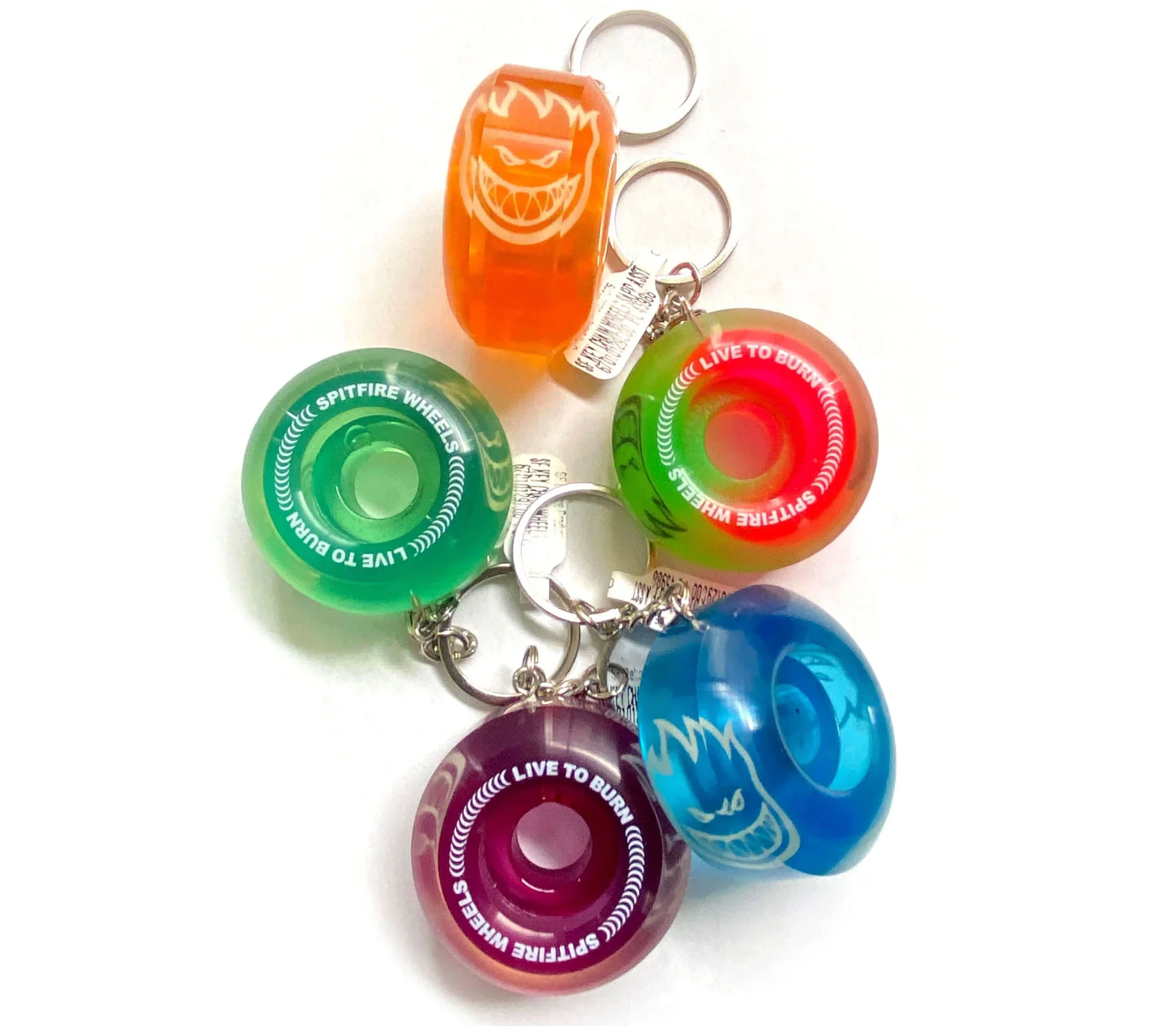 Colorful keychains with various designs on a white background