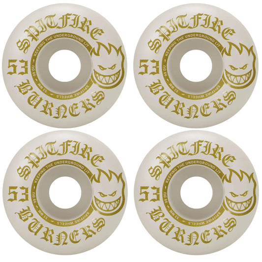 Four Spitfire skateboard wheels with gold and black text on a white background