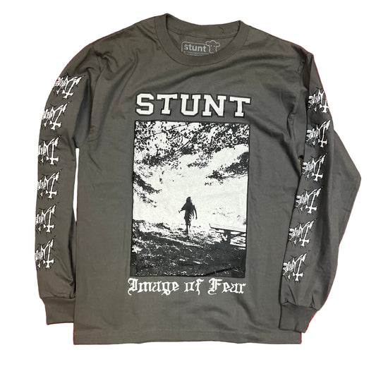 Gray long-sleeve shirt with 'Stunt' graphic design on a red and beige patterned background