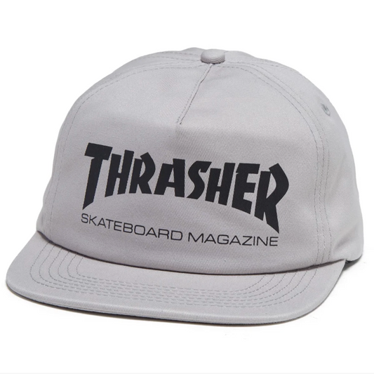 A light gray flat-brim baseball cap featuring the black Thrasher Skateboard Magazine logo on the front, set against a plain white background.