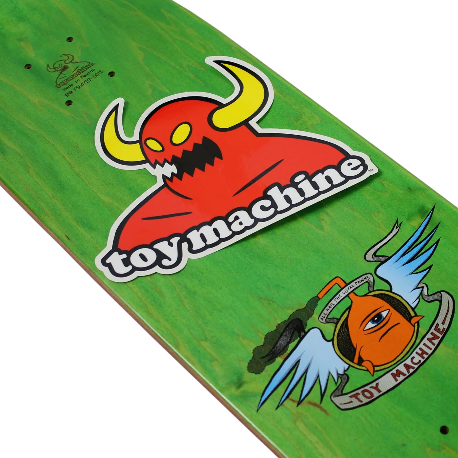 A close-up of a green skateboard deck featuring a large red horned monster graphic with the words 'toy machine' and a smaller orange winged character near the bottom right.