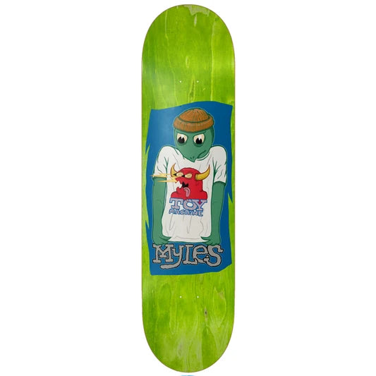 A skateboard deck with a bright lime green wood grain finish, featuring a large graphic in the center of a cartoon turtle wearing a white T-shirt with a red bull logo and the text 'MYLES'.