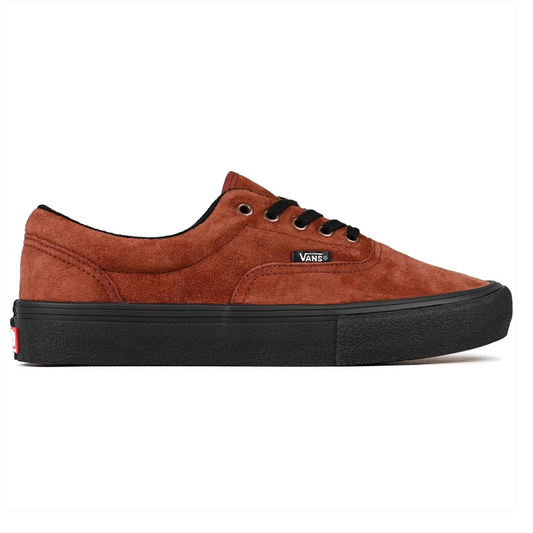 A Vans low-top sneaker in brown suede with a black rubber sole, black laces, and a black interior lining, shown in a side profile on a white background.