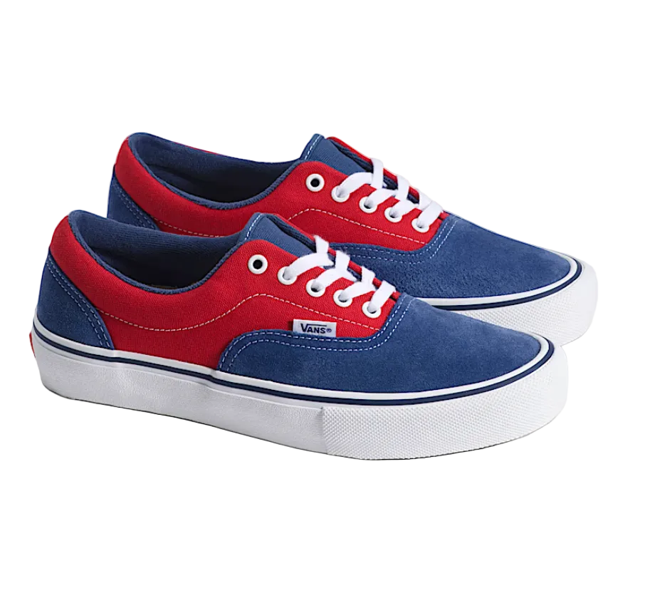 Red and blue sneakers with white laces on a light gray background