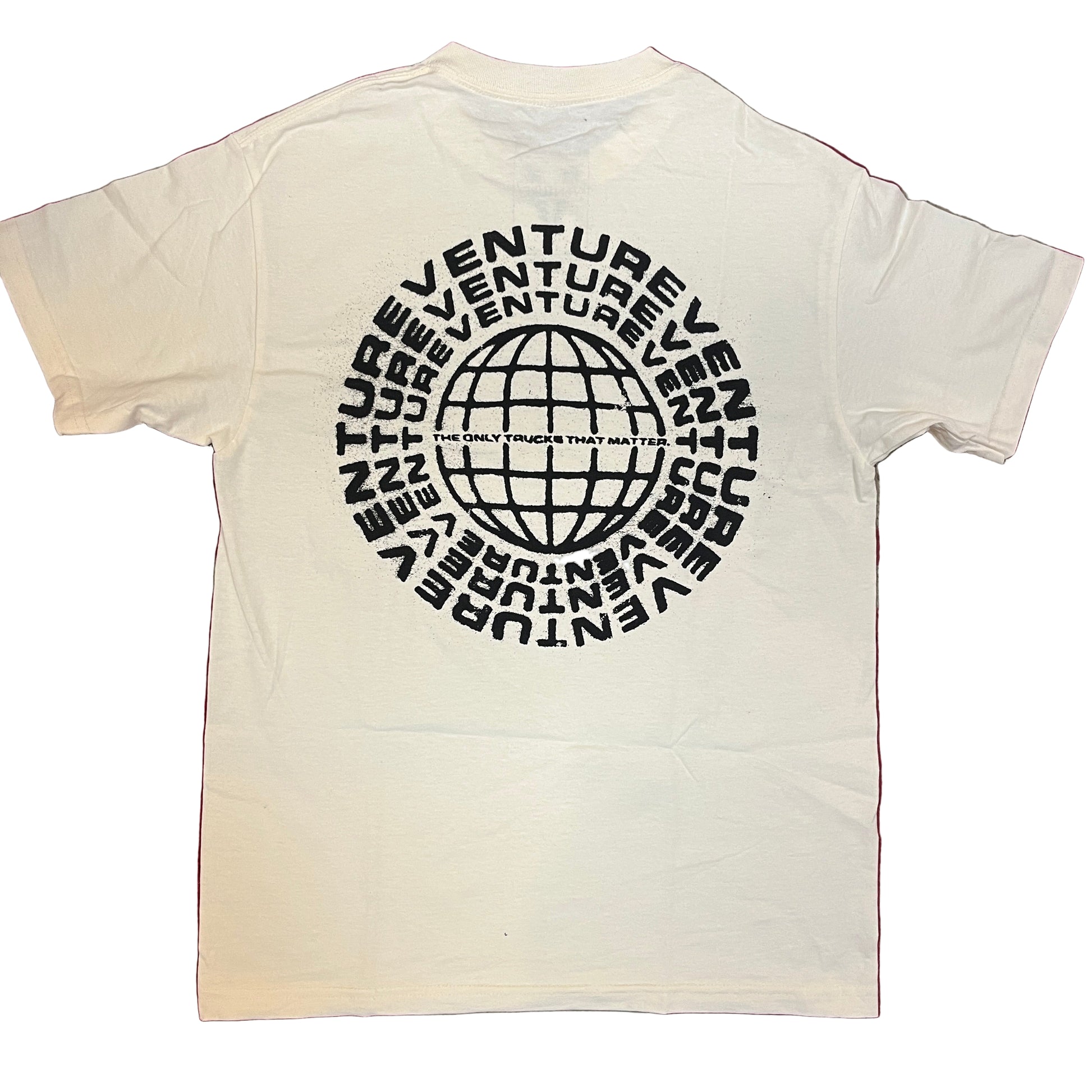 White t-shirt with black 'Venture' logo on a red and gray patterned surface