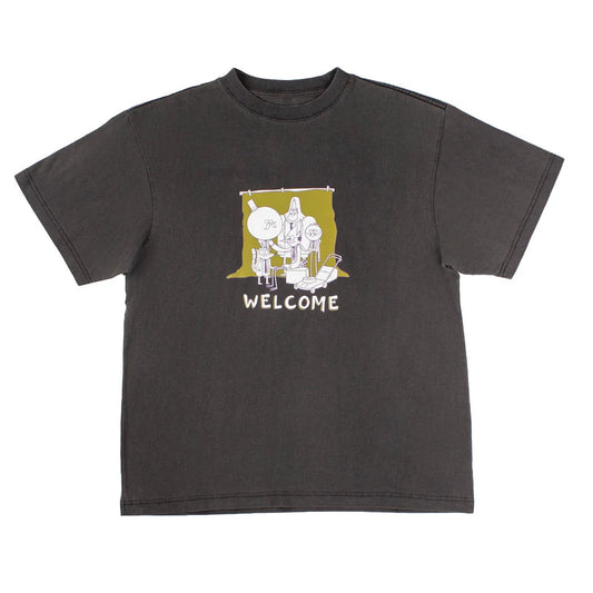 A dark charcoal gray short-sleeve t-shirt with a graphic print on the chest. The graphic features a white line-art illustration, with the word 'WELCOME' printed in white below it.