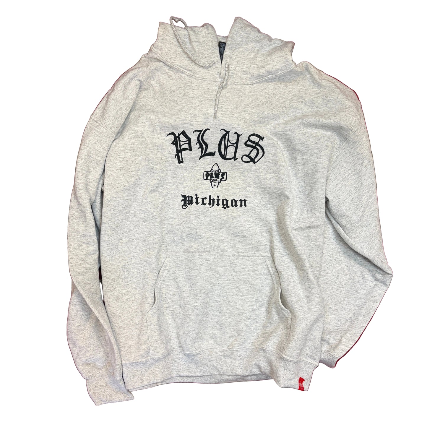 Gray hoodie with 'PLUS Michigan' text on a red and beige patterned surface