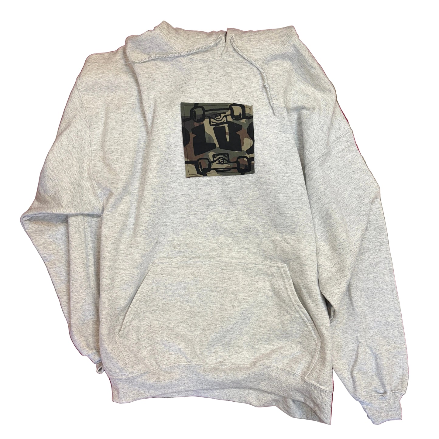 Gray hoodie with a graphic design on a red and beige patterned surface